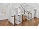 Elegant staircase with hardwood floors and white banisters leading to the upper level at 6470 Long Island Nw Dr, Atlanta, GA 30328