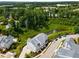 Picturesque aerial shot of a modern home next to a lush green area and pond with tree coverage at 2125 Parkside Ln, Roswell, GA 30076