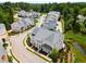 Scenic aerial view of an upscale neighborhood with beautifully landscaped homes and a tranquil pond at 2125 Parkside Ln, Roswell, GA 30076