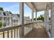 Spacious balcony overlooking the street with wood flooring and white pillars at 2125 Parkside Ln, Roswell, GA 30076