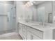 Elegant bathroom featuring a double vanity, granite countertop, sleek shower and modern fixtures at 2125 Parkside Ln, Roswell, GA 30076