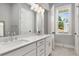 Elegant bathroom featuring a double vanity, granite countertop, sleek shower, modern fixtures, and a window at 2125 Parkside Ln, Roswell, GA 30076