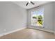 Bright bedroom features a ceiling fan and large window with a view of the landscaped yard at 2125 Parkside Ln, Roswell, GA 30076