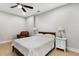Cozy bedroom features ceiling fan, hardwood floors, and a leather chair at 2125 Parkside Ln, Roswell, GA 30076