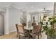Dining room with modern decor, and views into the open-concept living area and a view of the exterior at 2125 Parkside Ln, Roswell, GA 30076