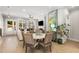 Open-concept dining room with bright neutral colors, view of the outdoor space, and view into the living area at 2125 Parkside Ln, Roswell, GA 30076