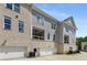 Exterior view of the garage doors, balconies, and brick and gray siding at 2125 Parkside Ln, Roswell, GA 30076