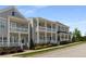 Beautiful townhomes with white porches, railings, and professionally landscaped gardens at 2125 Parkside Ln, Roswell, GA 30076