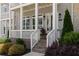 Inviting front porch with brick steps, fresh landscaping and a flower pot at 2125 Parkside Ln, Roswell, GA 30076