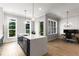 Modern kitchen featuring a large island, views from dual windows, and an adjacent office space at 2125 Parkside Ln, Roswell, GA 30076