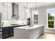 Bright kitchen features stainless steel appliances, a spacious island, and dual pendant lighting at 2125 Parkside Ln, Roswell, GA 30076