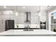 Modern kitchen with white cabinets, stainless steel appliances, and large island with white countertop at 2125 Parkside Ln, Roswell, GA 30076