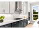 Well-designed kitchen with modern stainless appliances, white cabinets, dark counters and large window views at 2125 Parkside Ln, Roswell, GA 30076