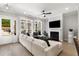 Bright and open living room with lots of natural light, modern fireplace and flat screen TV at 2125 Parkside Ln, Roswell, GA 30076