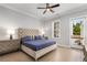 Comfortable bedroom with tufted headboard, matching nightstands, and access to a private balcony at 2125 Parkside Ln, Roswell, GA 30076