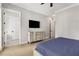 Comfortable bedroom with a flat-screen TV and a view into the en suite bathroom at 2125 Parkside Ln, Roswell, GA 30076