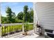 Charming patio with black railing, lush greenery, and stylish outdoor seating area at 2125 Parkside Ln, Roswell, GA 30076