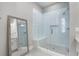 Modern walk-in shower with glass enclosure, subway tile, bench seating, and a gray tiled floor at 2125 Parkside Ln, Roswell, GA 30076