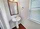 Bathroom featuring a pedestal sink, a window, and a mirror at 622 Madison Park Dr, Grayson, GA 30017