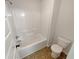 Bathroom featuring a tub with shower, a toilet, and a vinyl floor at 622 Madison Park Dr, Grayson, GA 30017