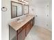 Bathroom featuring a double sink vanity with a stone countertop and dark wood cabinets at 622 Madison Park Dr, Grayson, GA 30017
