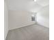 Cozy bedroom featuring neutral walls, carpet, and a bright window at 622 Madison Park Dr, Grayson, GA 30017