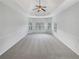 Spacious bedroom featuring a tray ceiling, ceiling fan, and three large windows at 622 Madison Park Dr, Grayson, GA 30017