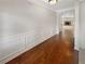 Long hallway with hardwood flooring and access to the living room at 622 Madison Park Dr, Grayson, GA 30017