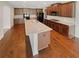 Spacious kitchen featuring hardwood floors, granite countertops, and an island with a sink at 622 Madison Park Dr, Grayson, GA 30017