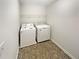 Practical laundry room with a washer, dryer, and overhead shelving at 622 Madison Park Dr, Grayson, GA 30017