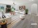 Bright living room with a fireplace, modern furniture, and lots of natural light at 622 Madison Park Dr, Grayson, GA 30017
