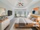 Staged main bedroom with a ceiling fan, sitting area, and stylish decor at 622 Madison Park Dr, Grayson, GA 30017