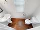 Powder room featuring hardwood flooring, a pedestal sink, and a toilet at 622 Madison Park Dr, Grayson, GA 30017