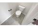 This powder room features a toilet, gray tile flooring and a dark colored towel bar at 622 Madison Park Dr, Grayson, GA 30017