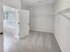Walk-in closet with shelves and open view to a bathroom with soaking tub and shower at 622 Madison Park Dr, Grayson, GA 30017