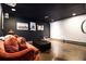 Cozy basement den featuring a comfortable sofa and dark walls, creating a relaxing atmosphere at 1379 Cambridge Ne Ct, Brookhaven, GA 30319