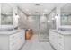 Luxurious bathroom with double sinks, marble countertops, and a modern glass shower at 1379 Cambridge Ne Ct, Brookhaven, GA 30319