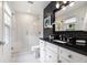 Modern bathroom with a glass enclosed shower, and black granite countertop at 1379 Cambridge Ne Ct, Brookhaven, GA 30319