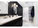 Modern bathroom features a double vanity, sleek fixtures, and a striking black accent wall at 1379 Cambridge Ne Ct, Brookhaven, GA 30319