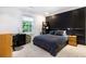 Modern bedroom with a dark accent wall, comfortable bed, and natural light at 1379 Cambridge Ne Ct, Brookhaven, GA 30319