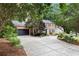 Two-story brick home features a long driveway, attached garage, and landscaped front yard at 1379 Cambridge Ne Ct, Brookhaven, GA 30319