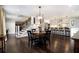 Open-concept kitchen and dining area with hardwood floors and modern lighting fixtures at 1379 Cambridge Ne Ct, Brookhaven, GA 30319