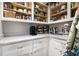 Well-organized pantry with open shelving, white cabinets, and ample storage space at 1379 Cambridge Ne Ct, Brookhaven, GA 30319