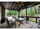 Covered outdoor patio seating area with ceiling fan and a view of the landscaped backyard at 1379 Cambridge Ne Ct, Brookhaven, GA 30319