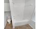 Bright bathroom features a tub and shower combination with natural light from the window at 2231 Mill Garden Pl, Buford, GA 30519