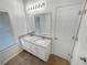 Bathroom features a double sink vanity, granite countertops, and a large mirror at 2231 Mill Garden Pl, Buford, GA 30519