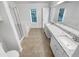 Bright bathroom with double vanity, soaking tub, and a glass-enclosed shower at 2231 Mill Garden Pl, Buford, GA 30519