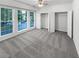 Bedroom featuring large windows, neutral walls, and closet storage at 2231 Mill Garden Pl, Buford, GA 30519