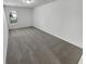 A bright, carpeted bedroom featuring a window for natural light and fresh, neutral paint for a relaxing atmosphere at 2231 Mill Garden Pl, Buford, GA 30519
