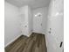 Welcoming entryway featuring wood-look flooring, closet with louvered door, and a bright front door at 2231 Mill Garden Pl, Buford, GA 30519